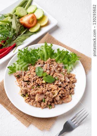 Local Thai food, Spicy minced pork salad (Larb Moo) eating with fresh vegetables on white background 130293682