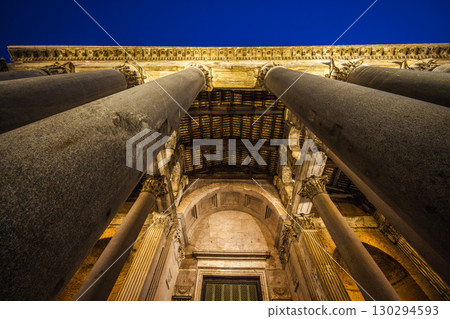 Low angle view of Pantheon entrance in Rome with massive ancient columns and illuminated architectural details at night 130294593