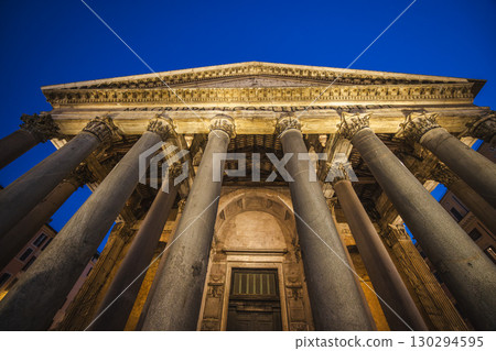 Ancient Pantheon in Rome beautifully lit at dusk with majestic stone columns and detailed facade under a twilight sky Ancient Pantheon in Rome beautifully lit at dusk with majestic stone columns and detailed facade under a twilight sky 130294595