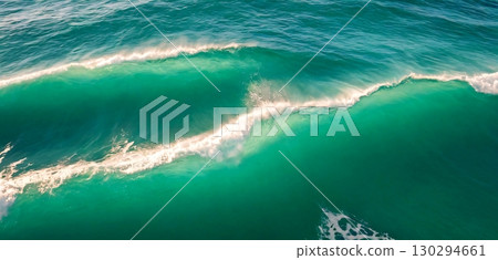 Vibrant ocean waves crashing with foamy white crests showcasing nature's raw power and beauty 130294661