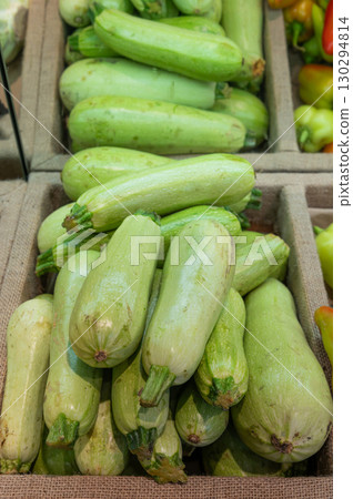 Green zucchini on the counter in a vegetable store Green zucchini on the counter in a vegetable store 130294814