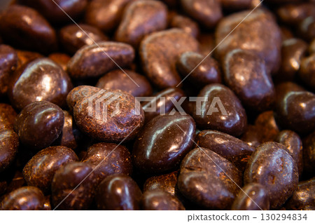 Nut balls covered with brown chocolate. Walnuts in chocolate glaze. Many top view 130294834