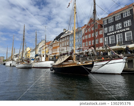 Scenic summer view of color buildings and boats of Nyhavn in Copenhagen, Denmark 130295376