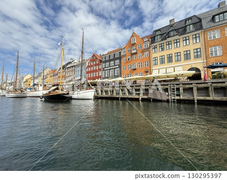 Scenic summer view of color buildings and boats of Nyhavn in Copenhagen, Denmark Scenic summer view of color buildings and boats of Nyhavn in Copenhagen, Denmark 130295397
