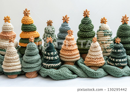 Lighting. Top view. Copy space. Crocheted bright Christmas trees on a white background. Christmas atmosphere. Creative hobby. Lighting. Top view. Copy space. Crocheted bright Christmas trees on a white background. Christmas atmosphere. Creative hobby. 130295442