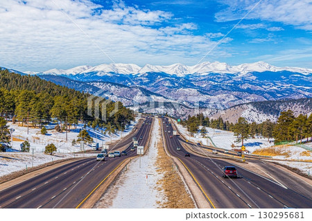 Interstate 70 in Rocky Mountains with snow covered peaks 130295681