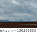 Mountain range visible beyond the brown fence 130296633