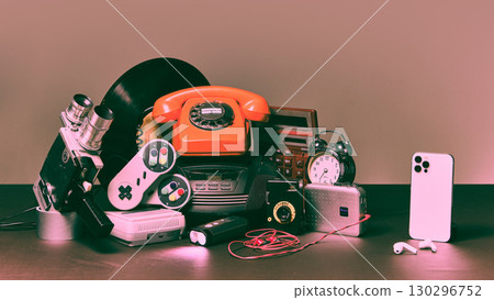 Retro technology objects with modern smartphone on dark surface 130296752