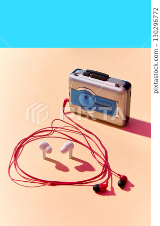Retro walkman player with modern earbuds and wired headphones 130296772