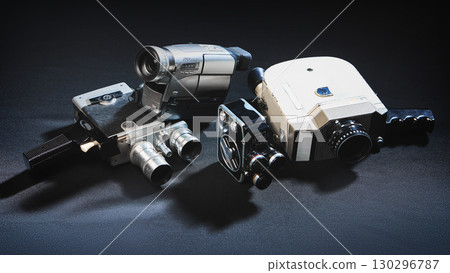 Collection of vintage and retro video cameras on dark surface 130296787
