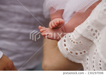 Tender Moment: Mother Holding Newborn Baby's Feet in White Lace, Soft Focus, Cream and Pale Skin Tones, Family Love, New Life Concept. 130297096