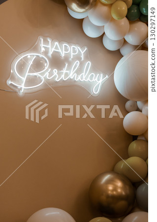 Elegant Birthday Backdrop with Neon Sign and Balloon Garland in Cream, White, and Gold Tones for Party Decorations. 130297149