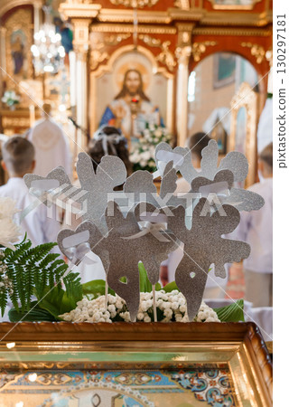Holy Wedding Ceremony with Silver Heart Decorations at Church Altar. White Flowers and Religious Art 130297181