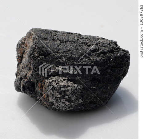 Raw Black Tourmaline Crystal Chunk with Granular Inclusions, Dark Tone, Mineral Specimen, Gemstone, Geology, Rough Stone Texture, Shadow Effects 130297262