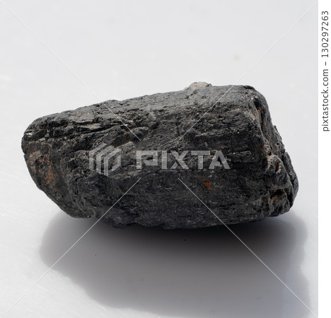 Natural Black Tourmaline Crystal Stone, Raw Mineral Specimen, Dark Grey Textured Rock, Geology, Metaphysical Healing, Shadow, Studio Shot 130297263
