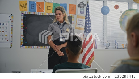 American Female TSA Security Officer Explaining Safety Rules to Young Students at Elementary School American Female TSA Security Officer Explaining Safety Rules to Young Students at Elementary School 130297413