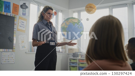 Children Sitting, Listening to Police Worker Guidance About Knowledge of Law and Responsibility 130297424