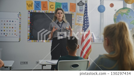 Female TSA Security Officer Explaining Safety Rules to Young Students at American Elementary School Female TSA Security Officer Explaining Safety Rules to Young Students at American Elementary School 130297434