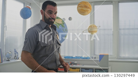 Male TSA Security Officer Uniform Giving Lecture, Explaining Safety Rules to Young Students in Classroom 130297449
