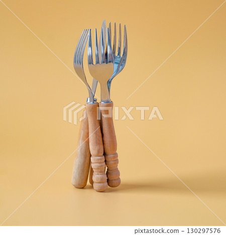 fork and spoon standing on background. fork and spoon standing on background. 130297576