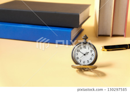vintage pocket watch on student table. 130297585