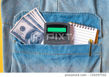 Bank note and calculator in pocket jean. 130297592