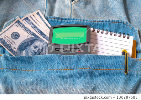 Bank note and calculator in pocket jean. 130297593