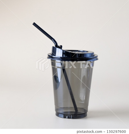 Black closed plastic glass on color background. 130297600