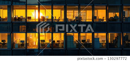 A large office building with many windows and a sun shining through them A large office building with many windows and a sun shining through them 130297772