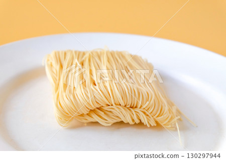 Dried long life noodles on color background. 130297944