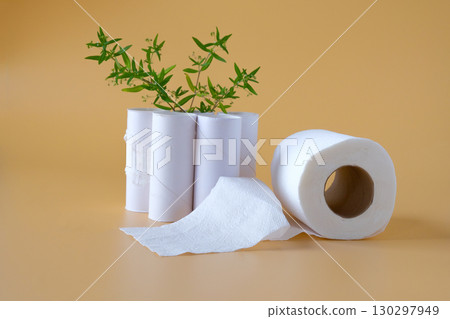 Tissues roll with green leaf on color background. 130297949