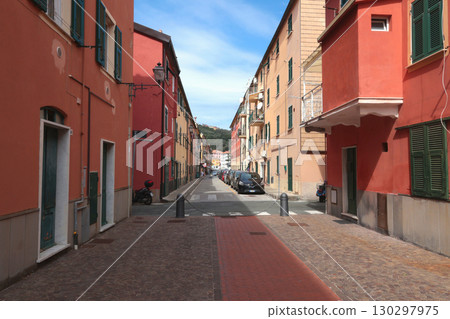 Old street in Italian countryside near sea. Traditional building. Sun day. Entrance, window to house. Nature and sky.  130297975