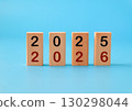 From 2025 to 2026, numbers on wood blocks. On color background. 130298044
