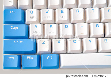 Computer keyboard on blue background. Top view Computer keyboard on blue background. Top view 130298372