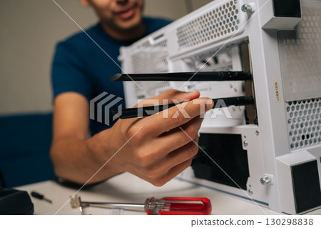 Cropped shot of technician installing dual-antenna WIFI module inside desktop computer case, improving wireless network connectivity and system performance. Concept of modern technology. Cropped shot of technician installing dual-antenna WIFI module inside desktop computer case, improving wireless network connectivity and system performance. Concept of modern technology. 130298838