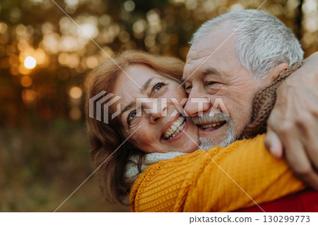 Senior couple enjoying autumn walk in nature, 130299773