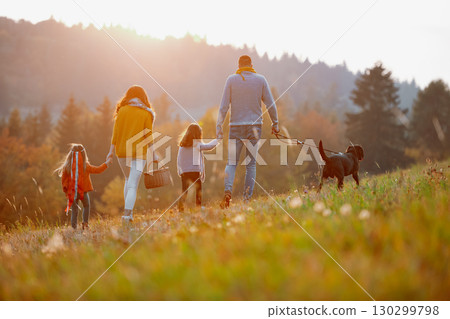 A portrait of young family with two small children in autumn nature at sunset. 130299798