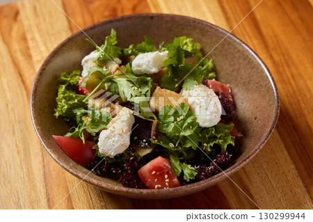 A delightful Fresh Salad with vibrant Greens, nourishing Quinoa, and creamy Cheese A delightful Fresh Salad with vibrant Greens, nourishing Quinoa, and creamy Cheese 130299944