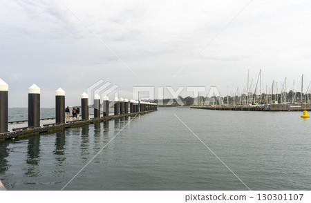 Geelong, Australia - January 2,2024 : Sailboats moor at Geelong Harbour with blue sky in Geelong, Australia on January 2,2024 . Geelong, Australia - January 2,2024 : Sailboats moor at Geelong Harbour with blue sky in Geelong, Australia on January 2,2024 . 130301107