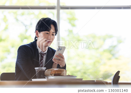 A man operating a smartphone 130301140