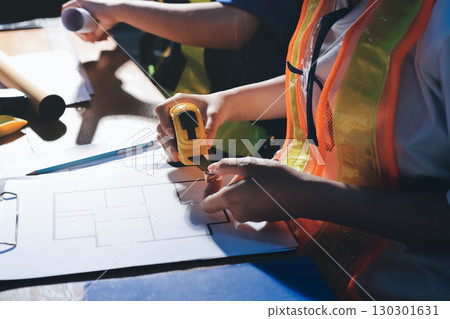 Closeup of team of industrial engineers meeting analyze machinery blueprints consult project on table in manufacturing factory. Working in manufacturing plant or production plant. 130301631