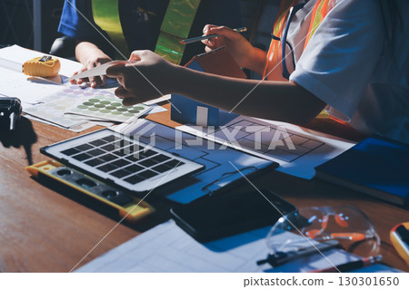 Closeup of team of industrial engineers meeting analyze machinery blueprints consult project on table in manufacturing factory. Working in manufacturing plant or production plant. 130301650