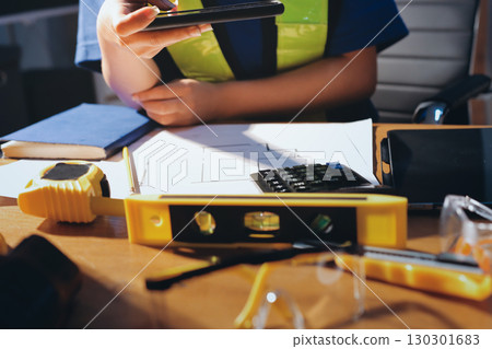 Closeup of team of industrial engineers meeting analyze machinery blueprints consult project on table in manufacturing factory. Working in manufacturing plant or production plant. 130301683