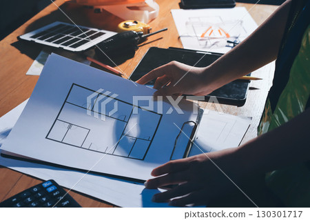 Closeup of team of industrial engineers meeting analyze machinery blueprints consult project on table in manufacturing factory. Working in manufacturing plant or production plant. 130301717
