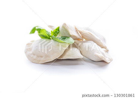 Frozen dumplings with herbs on a white background Frozen dumplings with herbs on a white background 130301861