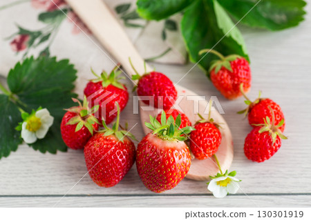 Top view of red strawberries on a light wooden table Top view of red strawberries on a light wooden table 130301919