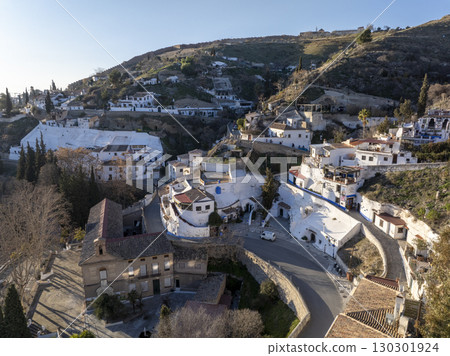 Sacromonte District in Granada, Spain. Aerial drone footage of the Traditional White Caved Dwellings at Sunset Light. 130301924