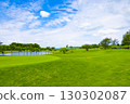 A resort golf course and green flag with a refreshing tropical blue sky, blue sea, and palm trees (Miyakojima City, Okinawa Prefecture) 130302087