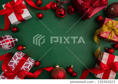 Christmas Gifts and Ornaments Border on Green Background 130302823