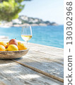 Coastal serenity fruit bowl and white wine by the sea. 130302968